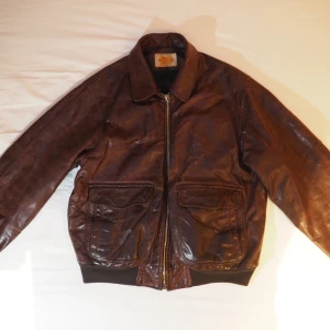 Brun vintage skinnjacka pilot modell - Snygg pilot/aviator skinnjacka med avtagbarpälskrage i mycket bra skick! Står storlek XXL men passar bra storlek L/XL. Snygg om man vill ha en oversize fit!