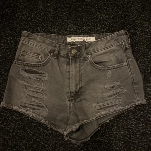 Basic svarta shorts - Korta svarta, lite gråaktiga shorts som är ”slitna” och knappt använda. De har dragkedja.