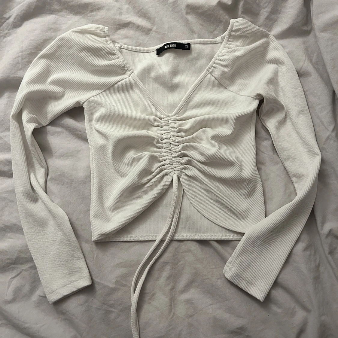 långärmad men snörning