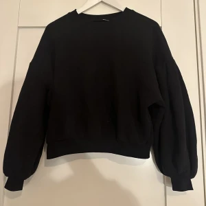 Svart sweatshirt - Säljer denna fina och sköna svarta sweatshirt med lite puffade armar🩷Tröjan är endast använd ett fåtal gånger och den är i gott skick! Kan ta fler bilder vid intresse!