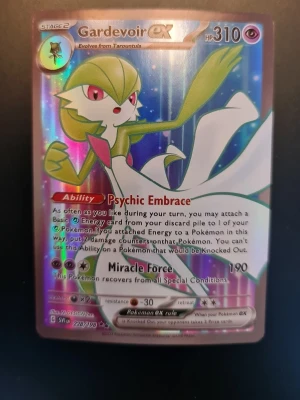 Gardevoir ex Pokémonkort - Säljer ett Gardevoir ex Pokémonkort med holografisk yta. Kortet har färger i grönt, vitt, blått och rosa och visar Gardevoir i en dynamisk pose. Text och effekter är på engelska och kortet har en cool glansig finish som gör det extra samlarvänligt.
