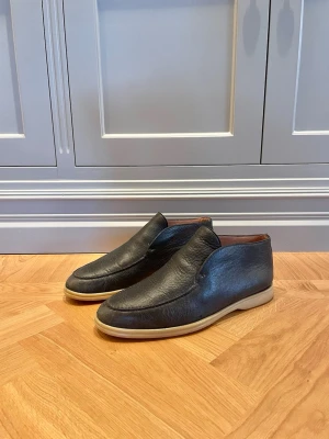 Loro Piana Open Walk (Stl 41) – Mörkgrönt Läder - Säljer ett par ikoniska Loro Piana Open Walk i mörkgrönt läder. En tidlös och elegant klassiker i mycket hög kvalitet.  Nypris: 1 100 EUR (ca 12 500 kr). Slutsålda på hemsidan.   Begagnade men i fint skick. Se bilderna.   Skoblock ingår ej.   Fraktar omgående.   Skriv vid frågor/funderingar.  
