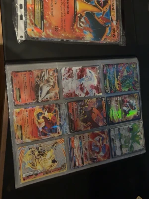 Pokémonkort samling i pärm - Stor samling Pokémonkort i pärm med flera holografiska och full art-kort. Blandade färger och motiv med populära Pokémon som Charizard, Lugia och Scizor. Perfekt för dig som vill utöka din samling eller börja samla Pokémonkort. Perm följer med och skriv om du har frågor kan ej mycket om sånthär men skriv gärna!