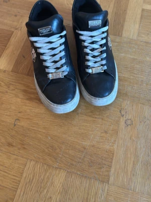 Philipp plein  - Säljer nu ett par svarta läder philipp plein skor med silver detaljer skorna är storlek 43. En liten repa på höger sko och lite creasade inte andvänt dom så jätte mycket skulle jag säga de ba å höra av er vid frågor. (Har bytt snören till dom så skickar med svarta original snören)