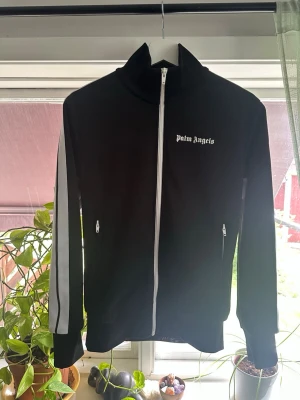 Palm Angels Zip svart - S  - Hej! Säljer denna mycket fina Palm Angels zip i storlek S eftersom den sällan kommer till användning. Köpt här på Plick! Äkthetsbevis syns genom Certilogo (i de bifogade bilderna); annars skriv för fler frågor eller funderingar! Pris går alltid att diskutera 👍