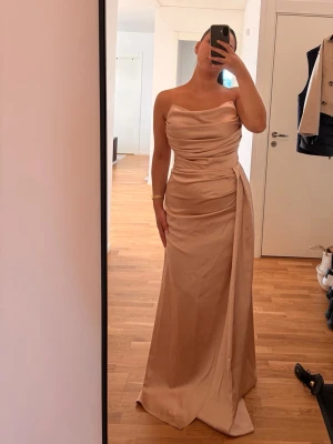 Vacker satin maxi klänning - Otroligt vacker klänning i fin kvalitet! Nypris: 2500 kr  Storlek 36-38. Fler bilder längre ned i min profil. Lite defekt i tyget, se bild. Första ägare, använd i få timmar    