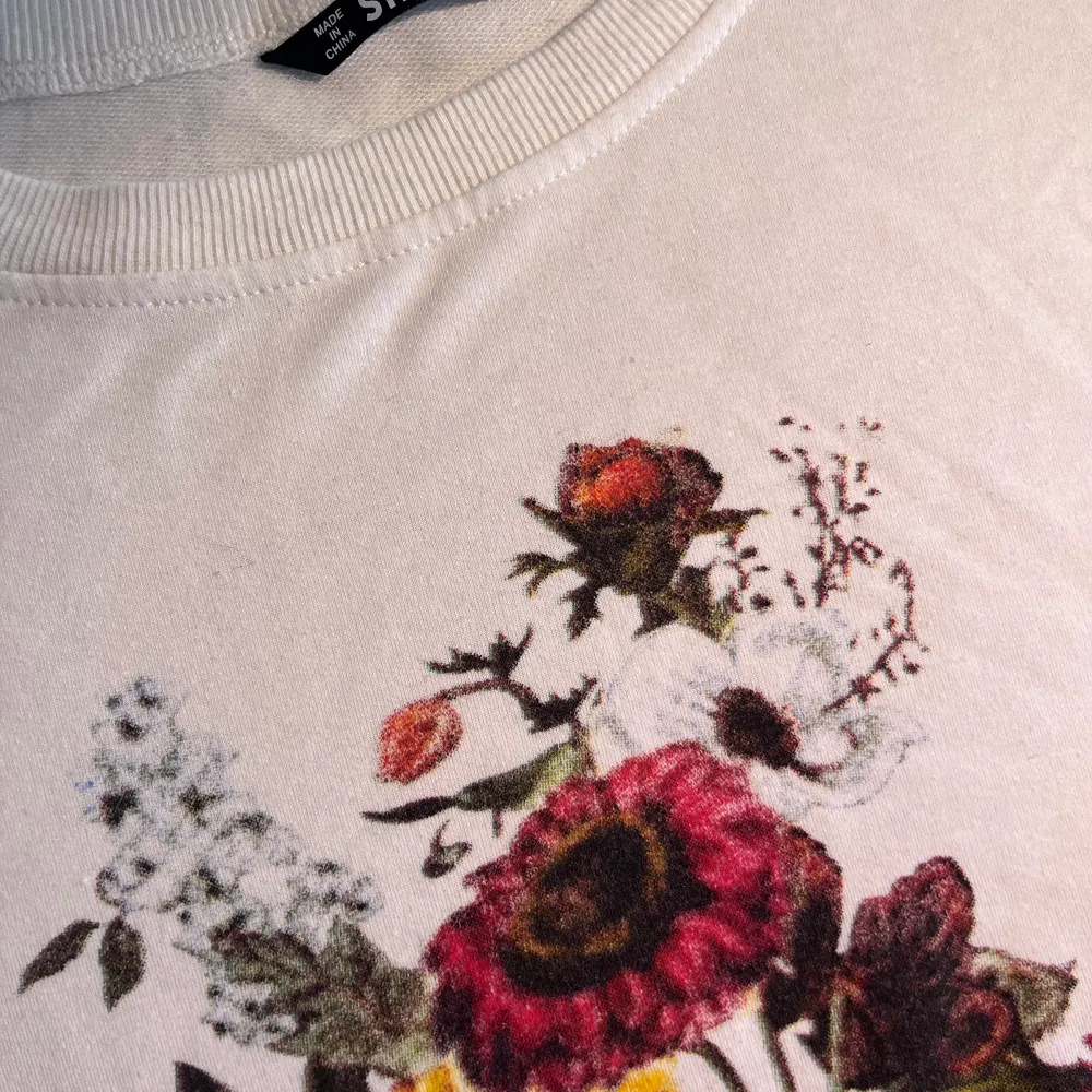 White blouse with lovely flowers print . Hoodies.