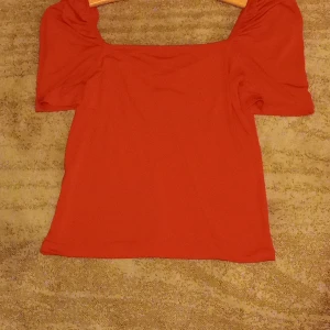 Hot red blouse.  - The blouse is worn 3 time no me. The blouse is still good looking.