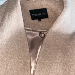 Kappa från Stockholm LM - Kappa i beige/rosa, aldrig använd 