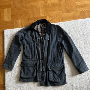 Barbour Tartan - Vaxad jacka från Barbour.  
