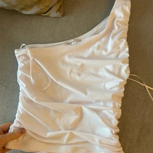 Topp från Stradivarius - Fin oanvänd topp från stradivarius i strl M (är mer xs/s). Fint rynkad i sidorna. 