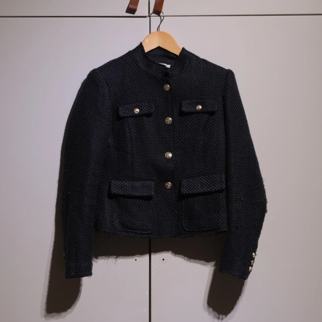 Blue Chanel-like blazer with gold buttons