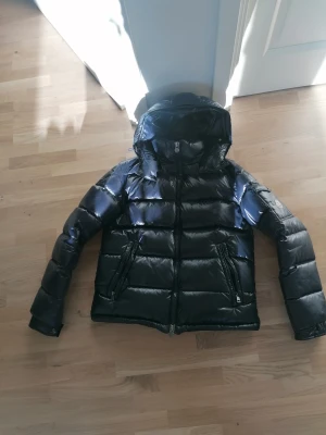 Moncler Maya Jacka  - Tjena, nu äre dags för mig att sälja min riktigt snygga Moncler maya navy i stl M. Den är i bra skick inga stora skador förutom på serien som har rivits upp lite men annars är den rätt hel. Kan gå ner i pris vid snabb och smidig affär.