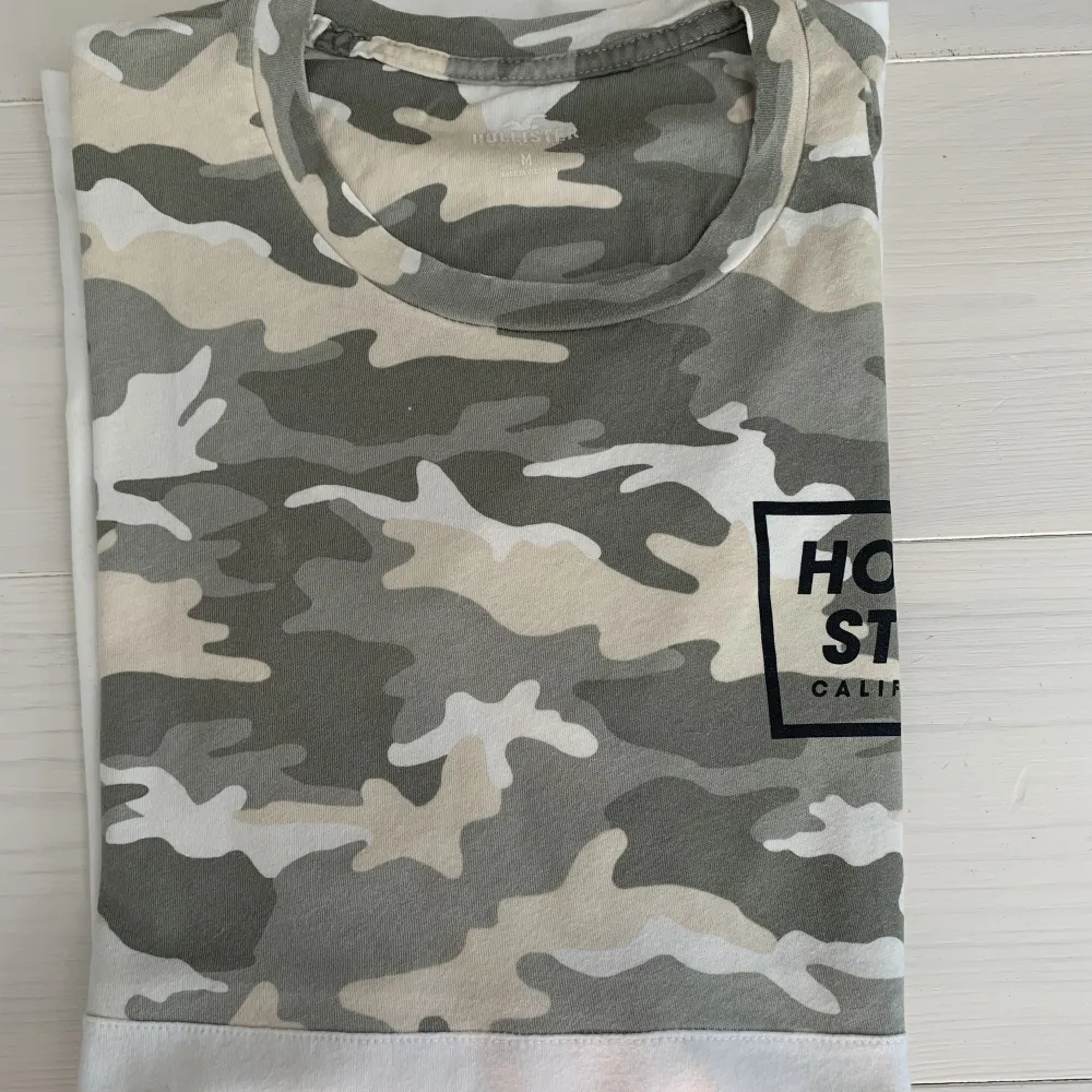 Fin T-shirt från Hollister delvis i  kamouflagemönster! Tröjan är använd ett fåtal gånger och i fint skick. . T-shirts.