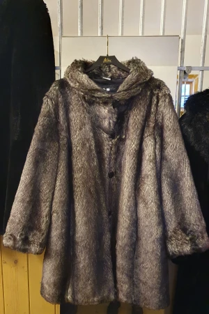 Fake fur  - Vacker fuskpäls vinterkappa. Knappt använd,ser ut som ny. Storlek 44 kan passar till storlek 46. Passa rymlig   Priset är exklusive Fraktkostnader Kappan är inte tung.  
