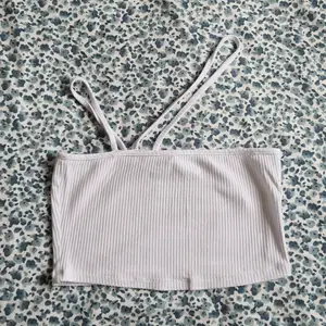 White crop top with a cross shoulder strap.  Size 36