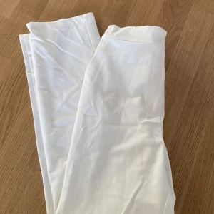Vita kostymbyxor  - Snygga kostymbyxor i rak modell och bra resår i midjan. 