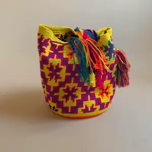 This bag was made in Colombia with colorful threads made of Cotton and Aloe.   Drawstring Closure with Fringed Tassels  30 CM/14 IN Length of Bag (not including Strap) 25 CM/11 IN Width 53 CM/ 20.9 IN Drop