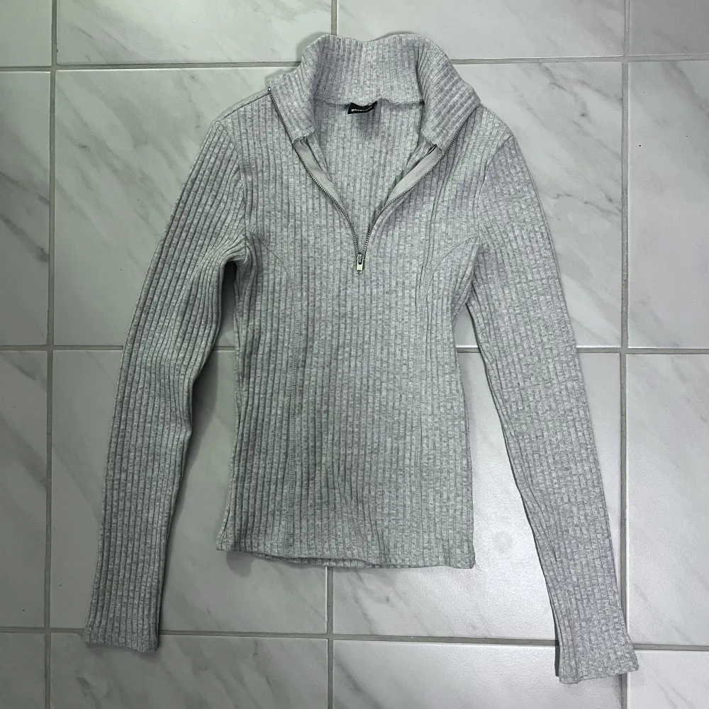 En grå zip tröja (dragkedja) från Gina Tricot i stl XS. . Toppar.