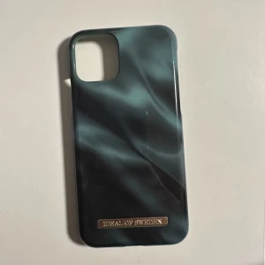 Ideal of sweden skal emerald satin - Ideal of sweden skal emerald satin till iphone 11 pro, sparsamt använd, har några små defekter i hörnen därav priset, kartongen medföljer, köparen står för frakt. Köpt för 299kr.