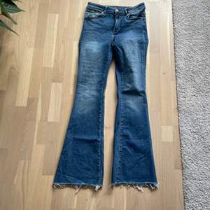 Blåa lite ”blekta” utsvängda jeans från BikBok. Storlek M