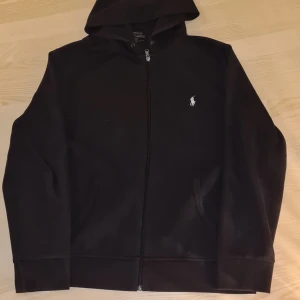 Polo Ralph Lauren Zip Hoodie - Säljer nu min i princip helt nya ralph lauren tröja. Den har blivit tvättad en gång, har använt den kanske 3. Föredrar att frakta den men det är möjligt att mötas upp. Nypris 1500kr. Byter gärna mot en i storlek M. Har ni frågor är det bara att skriva.