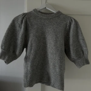 Stickad T-shirt från H&M - Grå stickad tröja från hm med ”puffiga armar” Färgen är lite ljusare i verklighet än på bild. Använd ganska flitigt där av priset🌟normal i storlek