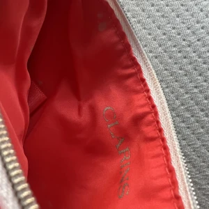 Necessär clarins - Necessär från Clarins. Superfint skick, endast nån liten fläck här o där som säkert går att tvätta bort. 