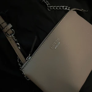Guess väska! - Aldrig använt, inga fel på den! Plånboks liknande väska som går att justera och ha över axeln 