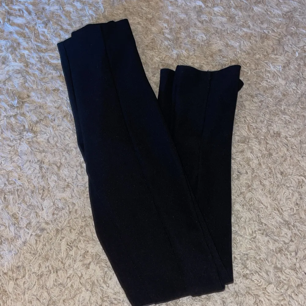 Säljer ett par svarta kostymbyxor från ginatricot i storlek XS. Köpa för 400kr och nästan helt oanvända. De har slits på båda sidorna vid slutet av änden. För mer detaljerad bild, kontakta mig!. Jeans & Byxor.