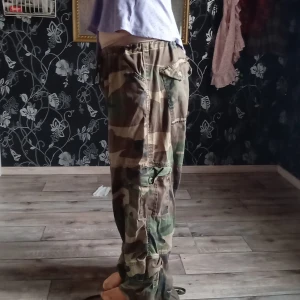  gröna/oliv  Kamouflage byxor!  - Gröna baggy kamouflage byxor. Säljer dom för att jag aldrig använder dom och för att jag tyckte att jag inte passar i dom. 