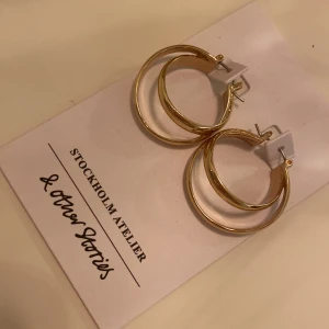 Örhängen ringar - Säljer ett par guldiga ringörhängen från &otherstories. Aldrig använda. Nypris 190kr.