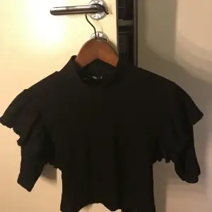 En svart tröja från zara med tyg på axlarna som jag säljer för att jag inte använder den, är använde ca 3-4 gånger