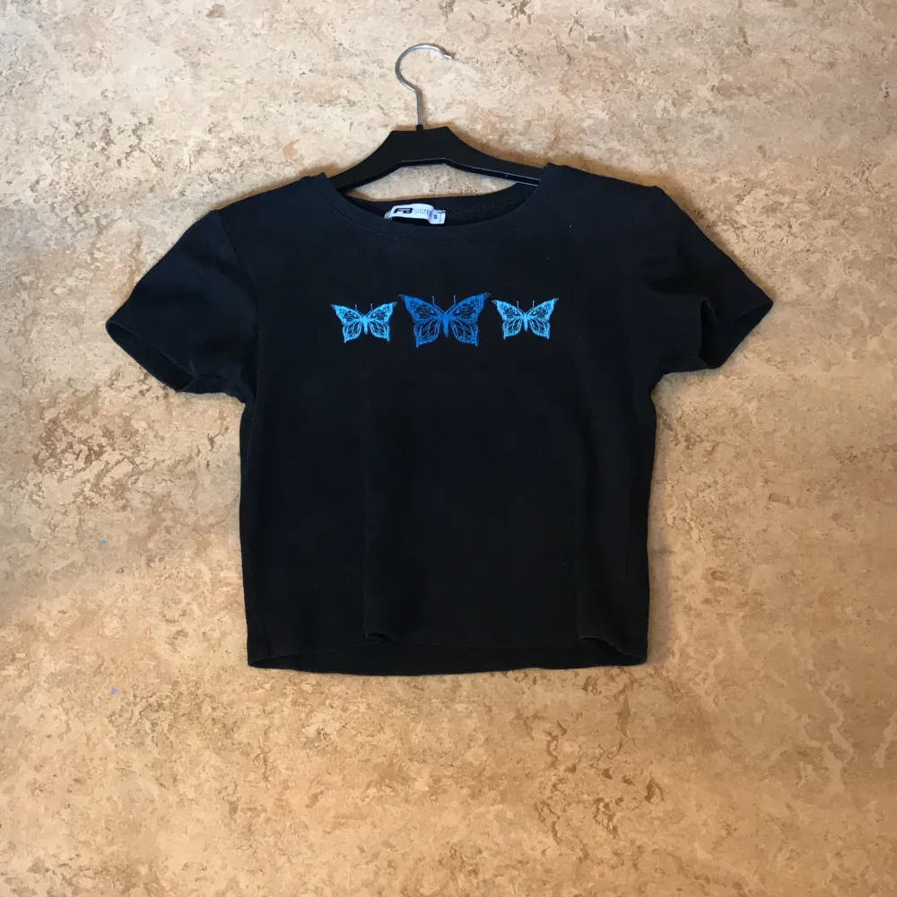 Jag har använt den här t-shirten typ fem gånger Den är jättefin det är tre fjärilar på t-shirten fjädrarna är blå. T-shirts.