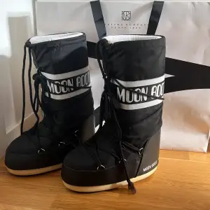 Säljer mina knappt använda moon boots köpta på nk i Sthlm för 1700kr säljer då jag har andra vinter skor inga defekter bara lite smutsig på sulan åå lite inuti ”dustbag” + nk påse med följer skriv vid frågor eller mer bilder! STORLEK 35-38