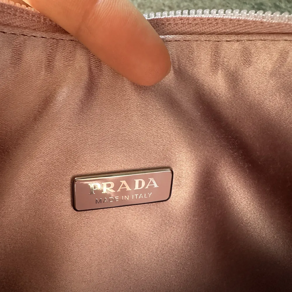 This mini hobo bag, an iconic Prada style, comes in a luxurious satin version studded with crystals and decorated with the emblematic enamel triangle logo.. Väskor.