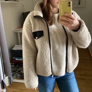 Teddy jacka - En beige Teddy jacka från Lindex i storlek XS. Ganska välanvänd så på vissa ställen ser den lite tuffsig ut (de bild 3). Köparen står för frakt.