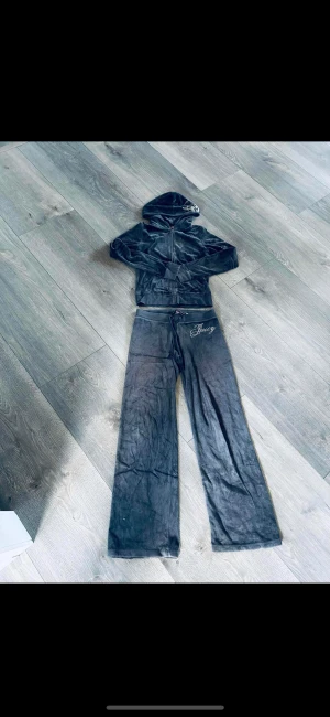 juicy couture - Säljer min systers juicy couture ställ, en Hoodie och ett par byxor.  Säljer hels settet ihop!  Använd men i fint skick, inga fläckar/hål eller liknande.  Färgen är mörkgrå, köpt i italien.  Storlek S i båda delarna. 