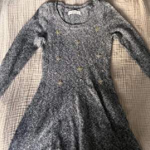 En stickad klänning fran abercombie kids i storlek L. Passar Xs. Jättefina detaljer med blommor i diamanter 