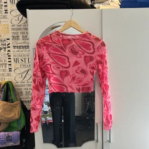 Rosa crop top  - Rosa crop top från SHEIN i storlek s/m med hjärt tryck. Den är ganska genomskinlig så man behöver nånting under.