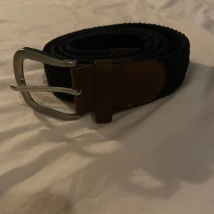 Flätat bälte - Tja, säljer mitt mörk blåa med lite beige/bruna detaljer som är 85cm långt hör av er vid frågor eller funderingar 