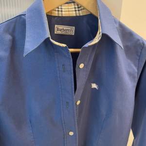 Ovanlig snygg burberry skjorta i färgen blå, skick 9/10, är storlek m men sitter som en en s