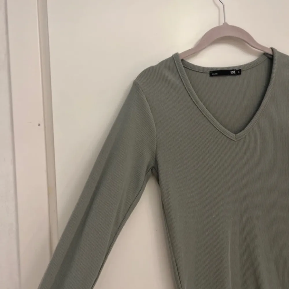 Ribbad långärmad tröja med v-ringning i grön från lager 157 i storlek S. Tröjor & Koftor.