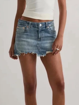 Blå jeanskjol - Trendig blå jeanskjol i kort modell med rå, fransig kant nertill. Kjolen har klassiska fem fickor, bälteshällor och knappstängning framtill. Perfekt för dig som gillar en avslappnad och cool stil. Helt oanvänd, med prislapp.