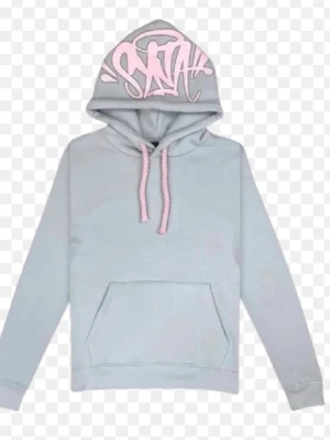 Ljusgrå hoodie med rosa detaljer - Snygg ljusgrå hoodie med rosa dragsnören och graffiti-inspirerad text i rosa på huvan. Klassisk känguruficka framtill och mjukt material som känns skönt mot huden. Perfekt för en chill och avslappnad stil.