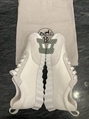 H E R M E S skor - Snygga vita sneakers från H&M. Riktigt feta nu till sommaren för bra pris. Har lite smuts på sig men inget stort. Använd ett par gånger men riktigt feta skor🔥🔥✅