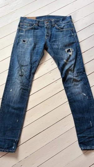 Dondup Jeans - •Snygga Dondup Jeans med slitningar i modellen Lucky •Jeansen är i storlek 33 • Passform: Modellen på bilden är 183 cm lång, väger 72kg