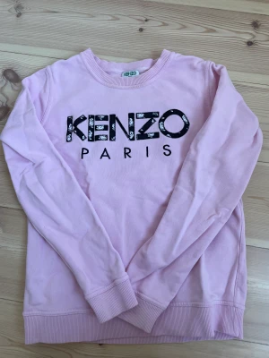 Kenzo collegetröja - Rosa kenzo collegetröja i fint skick. Använd ett fåtal gånger. Den är i storlek XS (dock något liten i storlek)