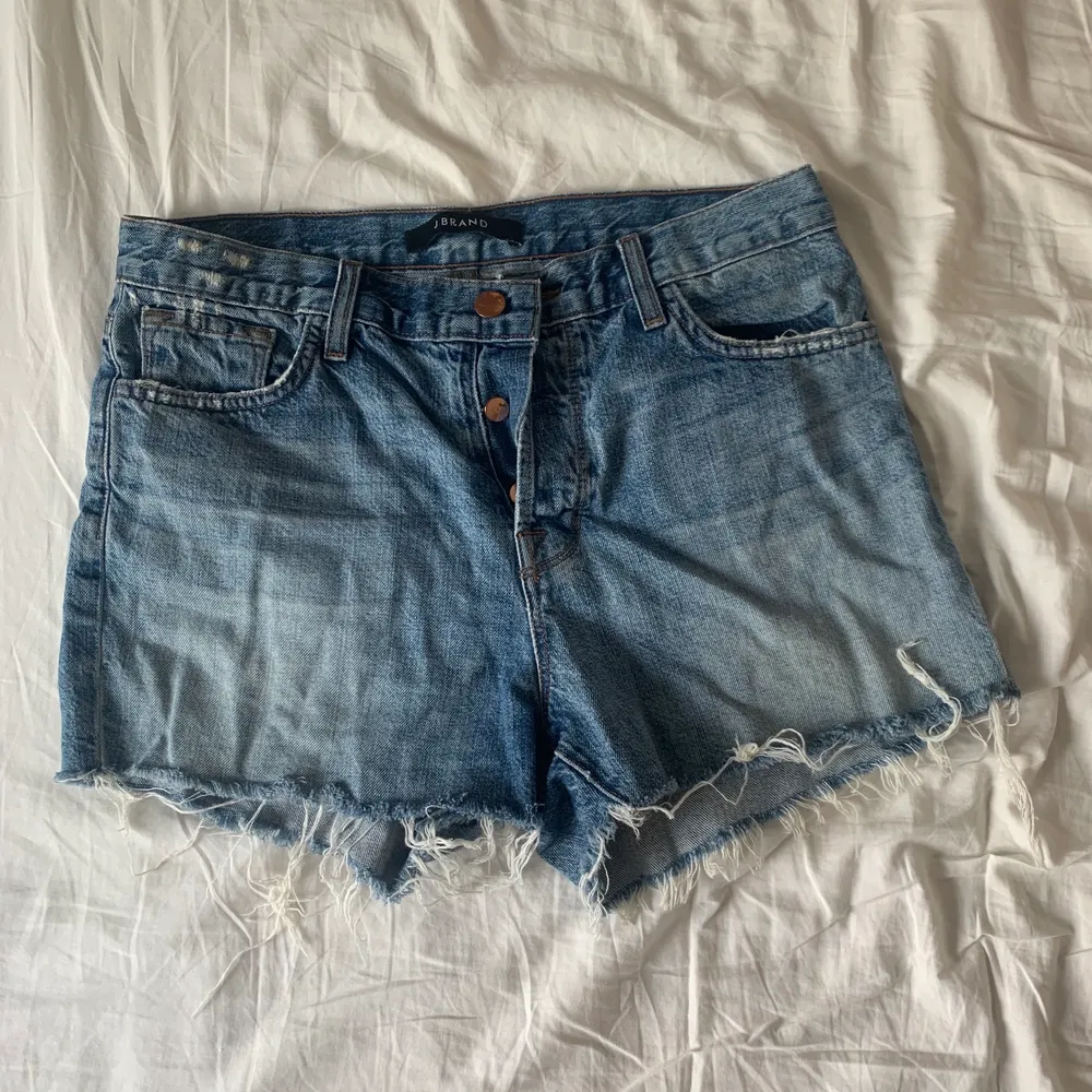 J Brand denim shorts in size 27. Low to mid-rise. Slightly distressed. Worn a few times. No signs of wear and tear.. Shorts.