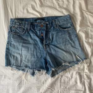 J Brand denim shorts in size 27. Low to mid-rise. Slightly distressed. Worn a few times. No signs of wear and tear.